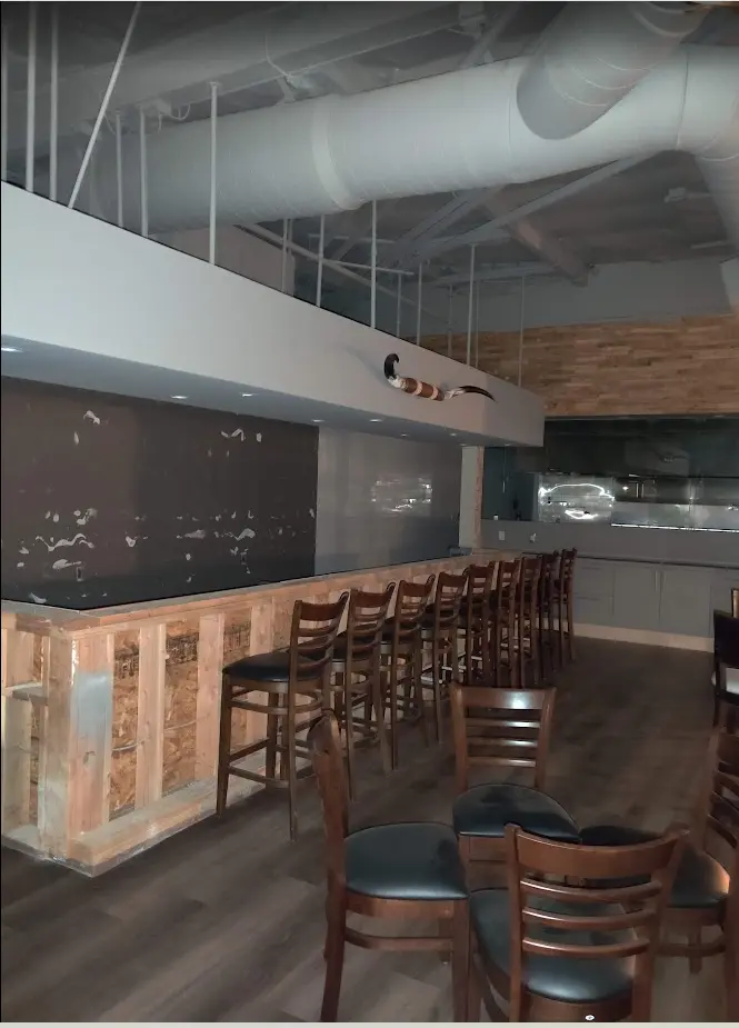 Beach Pit BBQ dining and service-counter interior during tenant improvement work